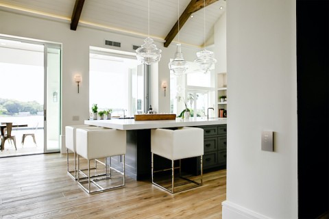 Luxury kitchen with Lutron Palladiom shades on the windows.