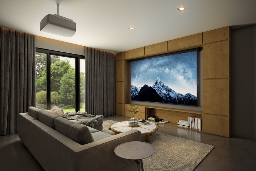 A home theater featuring a ceiling mounted projector and motorized screen.